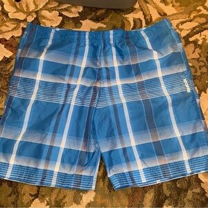Reebok swim trunks in classic blue plaid. Board shorts dry fast and look sharp.